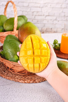 Fresh Kate Mango from Panzhihua Sichuan China - Hand Holding Diced Tropical Fruit in Wicker Basket