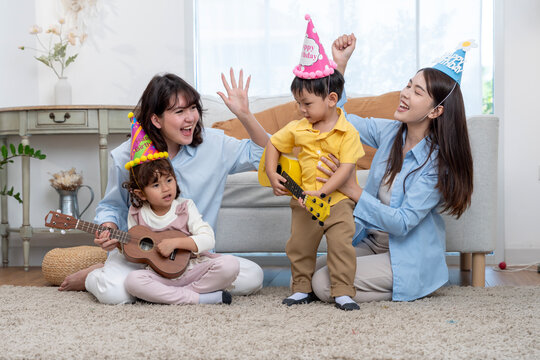 Asian Family Celebrating Kids Birthday Party Playing Ukulele