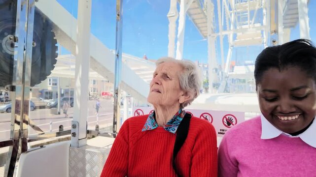 Weymouth Dorset England UK. 02.07.2026. Video. Two women of different ages and ethnicities share a joyful moment while riding on a Ferris wheel.