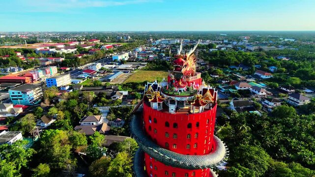Aerial view pulling back from the giant Dragon Temple Wat Samphran revealing surrounding landscape, Nakhon Pathom, Thailand