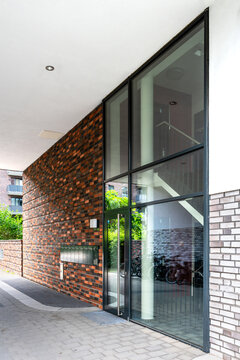 Front door of a modern apartment building in summer