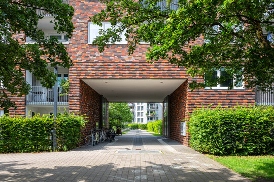 Driveway towards a modern apartment building in summer