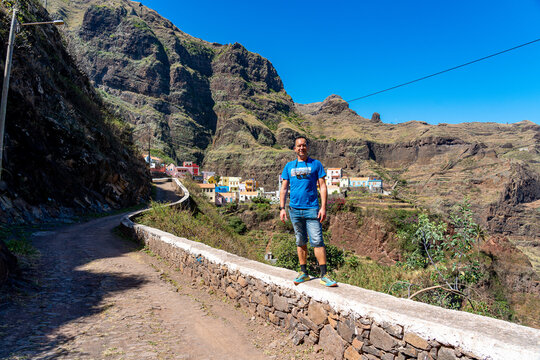 A white European man in a blue T-shirt in the area around the mountains of Santo Ant&atilde;o in Cape Verde.