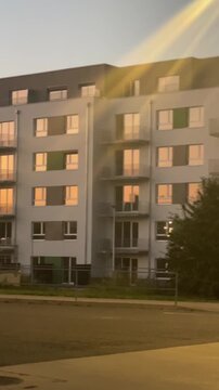 Vertical. Modern multi story residential apartment building in the evening. Contemporary urban architecture, residential living, and new real estate development in a growing city.