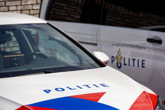 Parked Dutch police van and car