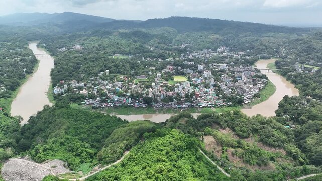 Aerial view flying over rangamati cityscape and kaptai lake bend