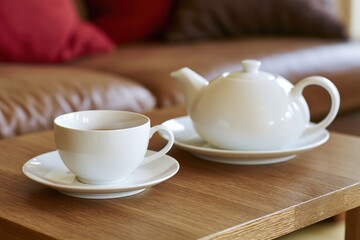 Fototapeta premium The Teapot and Teacup on Wooden Table in Cozy Living Room