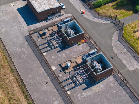 Aerial view of oil cooled high voltage transformer units at electrical substation