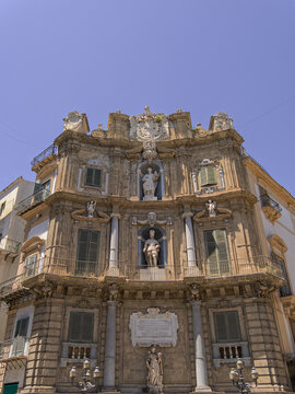 Capturing the stone masonry of the Kalsa corner at Palermo's Quattro Canti, this image highlights the classical columns, ornamental crests, and allegorical sculptures of  famous "Teatro del Sole."