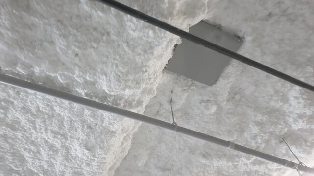Polyurethane spray foam insulation coating on commercial building ceiling