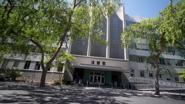 The Legislative Office Building in Sacramento, California shows its entrance and surrounding trees on a clear day.