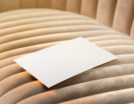 Blank white card mockup template on beige upholstered chair