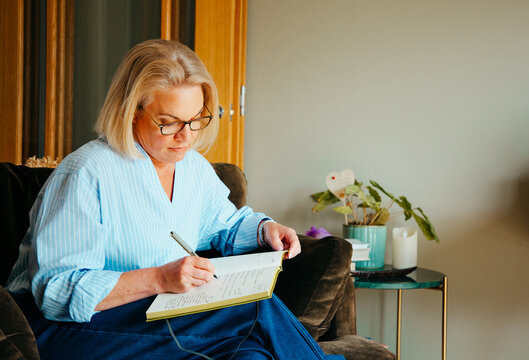 Portrait of middle aged woman writing in a notebook