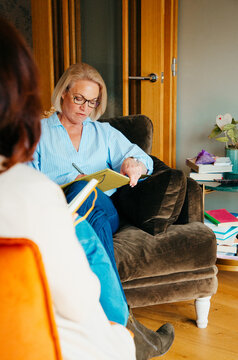 Smart attentive female taking notes during a conversation