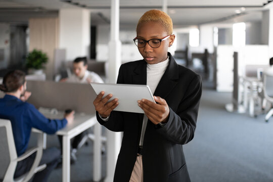 Black female manager browsing digital tablet