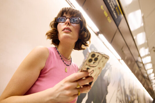 Attractive woman rides an escalator