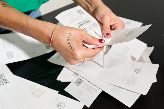Hands sorting paper tickets