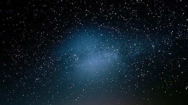 A vast expanse of the night sky, twinkling with countless stars and a faint celestial glow