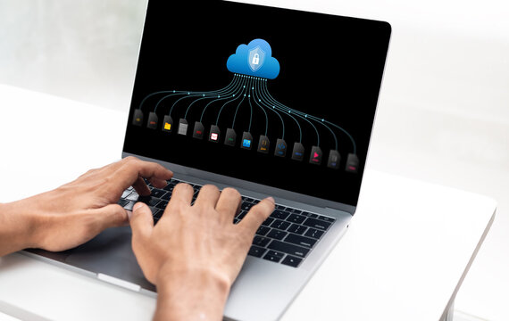 Business professional accessing secure cloud storage on laptop. Remote worker managing digital files and data online with encrypted technology.
