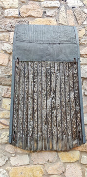 Traditional spanish threshing board on stone wall