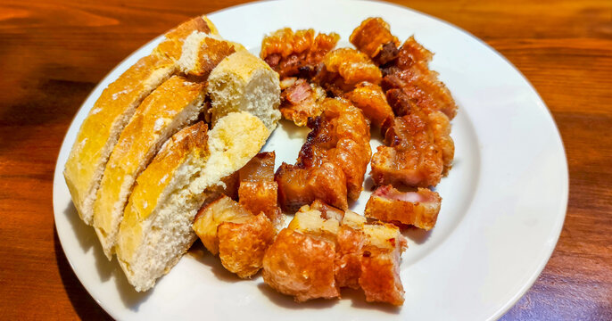 Torrezno de soria serving with bread on plate