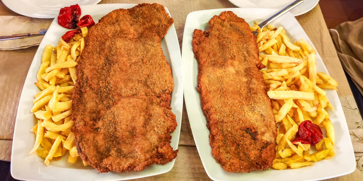 Two cachopos plates serving traditional asturian food