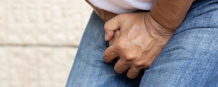 Old Southeast Asian man hand holding genitalia, concept of bladder UTI urinary tract infection or bladder infection, premature, ejaculation, fertility, prostate cancer disease, header crop