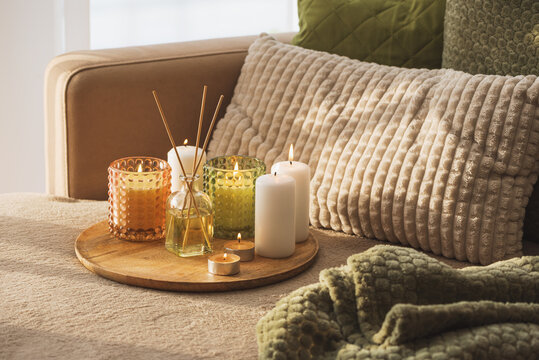 Home interior creating cozy relaxing atmosphere with candles and aroma diffuser