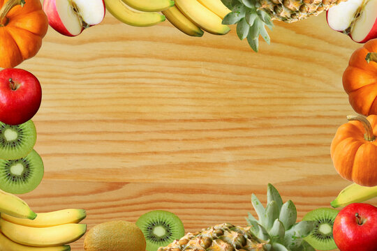 Frame of Colorful Assorted Fresh Ripe Fruits on Natural Wooden Background
