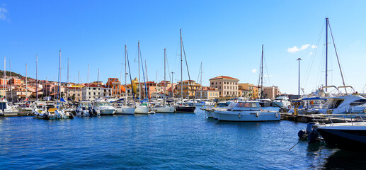 Fototapeta premium Yachts and sailboats in the port of Cala Gavetta in La Maddalena, capital city of the eponym archipelago located in the Mediterranean Sea in north-east of Sardinia, Italy