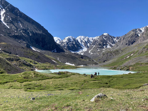 Hiking to the high-mountain lake Karakabak in the Altai Mountains in summer. Tourism in Russia. Northern Chuya Range, Altai Republic