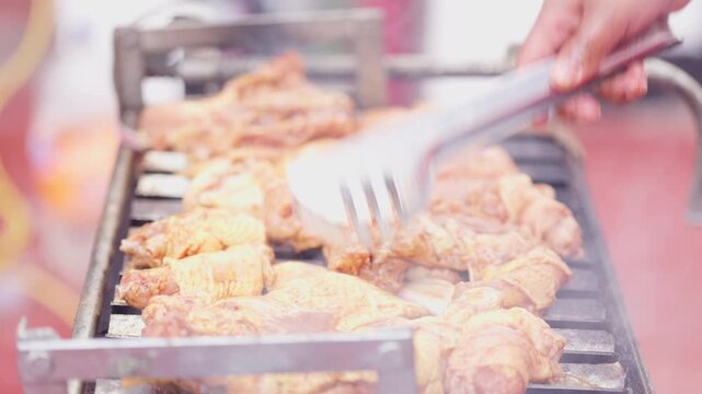 Close Up of Delicious Seasoned Chicken Sizzling on BBQ Grill Grate
