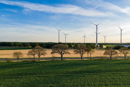 Wind mill for renewable electric energy production. Wind mill for renewable electric energy production. Windmill in a rural area. Offshore wind park. Alternative renewable energy generation