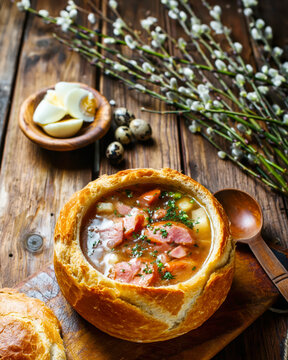 Traditional Polish Żurek Soup Served in Bread Bowl with Sausage and Eggs. AI generative.