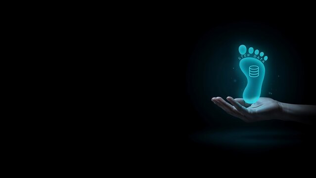 Human hand holding glowing digital footprint icon representing personal data tracking