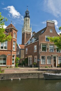 Bakenesserkerk Church Spire and Historic Houses along Canal in Haarlem