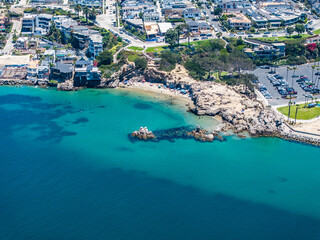 Fototapeta premium Aerial landscape view of Entrance Channel with Pirates Cove Beach next to Corona del Mar State Beach, located in Corona del Mar, a seaside neighborhood in the city of Newport Beach, California,