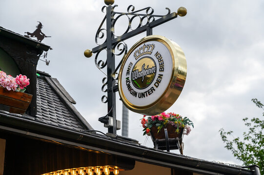 Iserlohn, Germany - July 19, 2026: Warsteiner beer advertising sign mounted on an ornate metal bracket during Kiliankirmes Letmathe