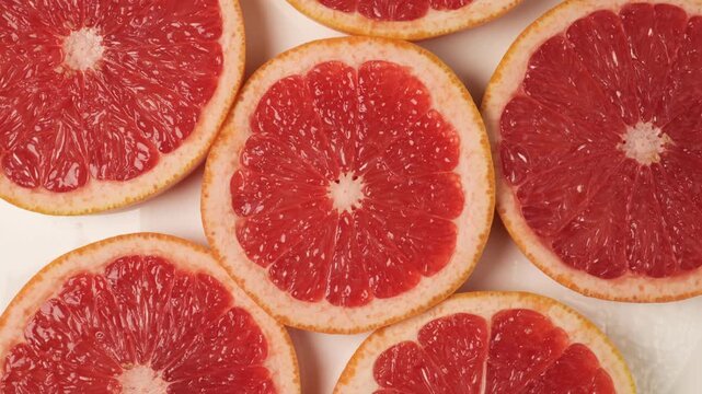 Rotating grapefruit slices on a white background