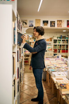 Stylish man browsing literature in bookstore