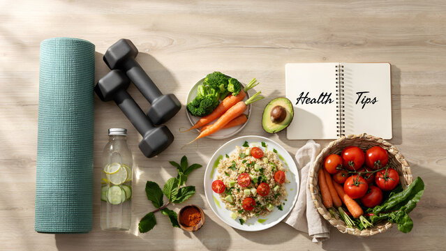 Healthy lifestyle yoga mat dumbbells salad vegetables water bottle notebook wooden surface highlighting fitness nutrition balance and wellness