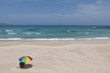 Colorful parasol offering shade on malpica beach © Azulblue