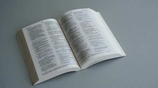 Open Bible with many pages turned in a study room