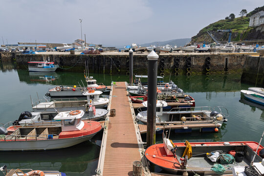 Fishing boats docked in malpica harbor along the coast