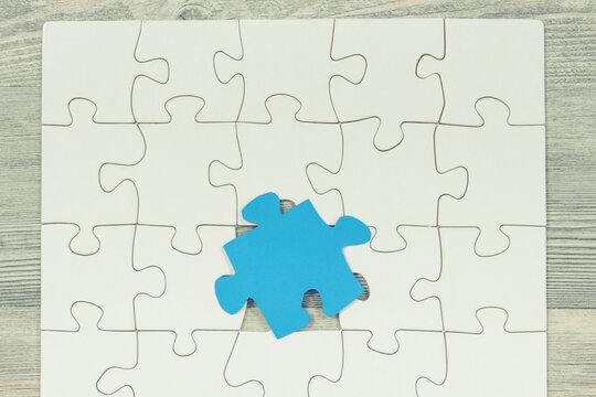 White and blue puzzle as symbol of Autism Spectrum Disorder
