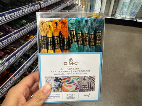 Mesa, Arizona - June 27, 2026: Hand holds a package of DMC Anniversary package of embroidery floss