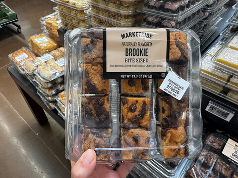 Mesa, Arizona - June 27, 2026: Hand holds Marketside bakery brookie (brownie cookie) bars sold at a Walmart store