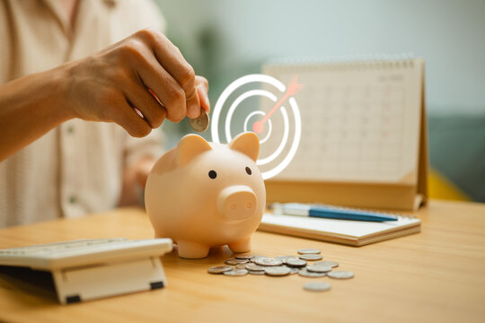 Building savings goals with a piggy bank, coins and budget planning for financial security and future success.