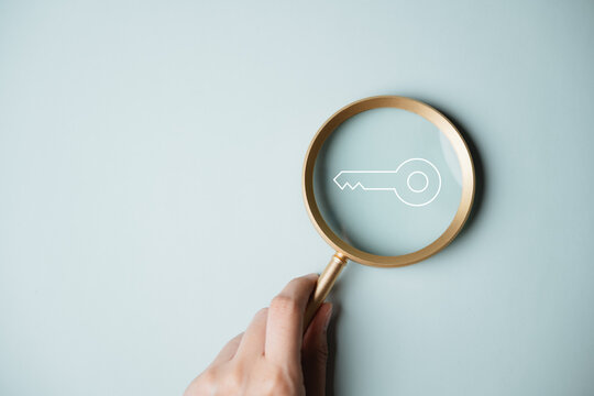 Magnifying glass highlighting a digital passkey symbol for passwordless authentication, secure identity, and cyber protection.