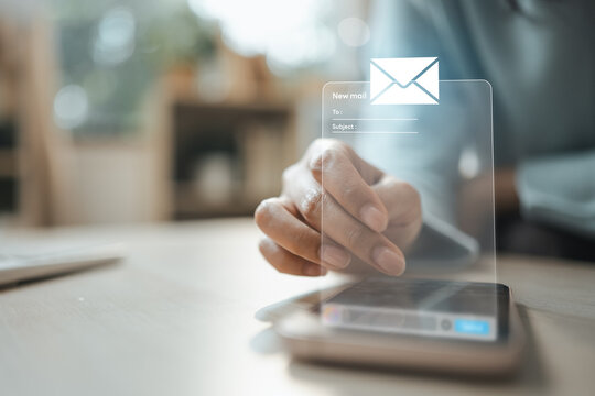 Business user sending email from a smartphone with digital messaging interface and notification.